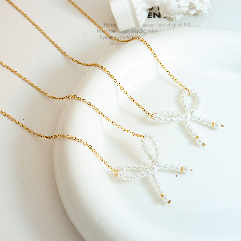 IMITATION PEARL BOW NECKLACE