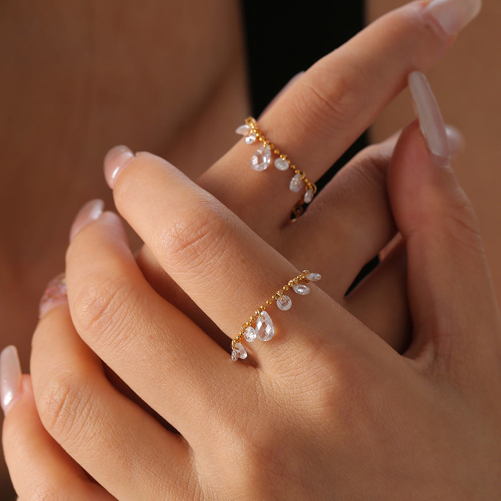 SEVEN CRYSTAL RINGS WITH TASSELS