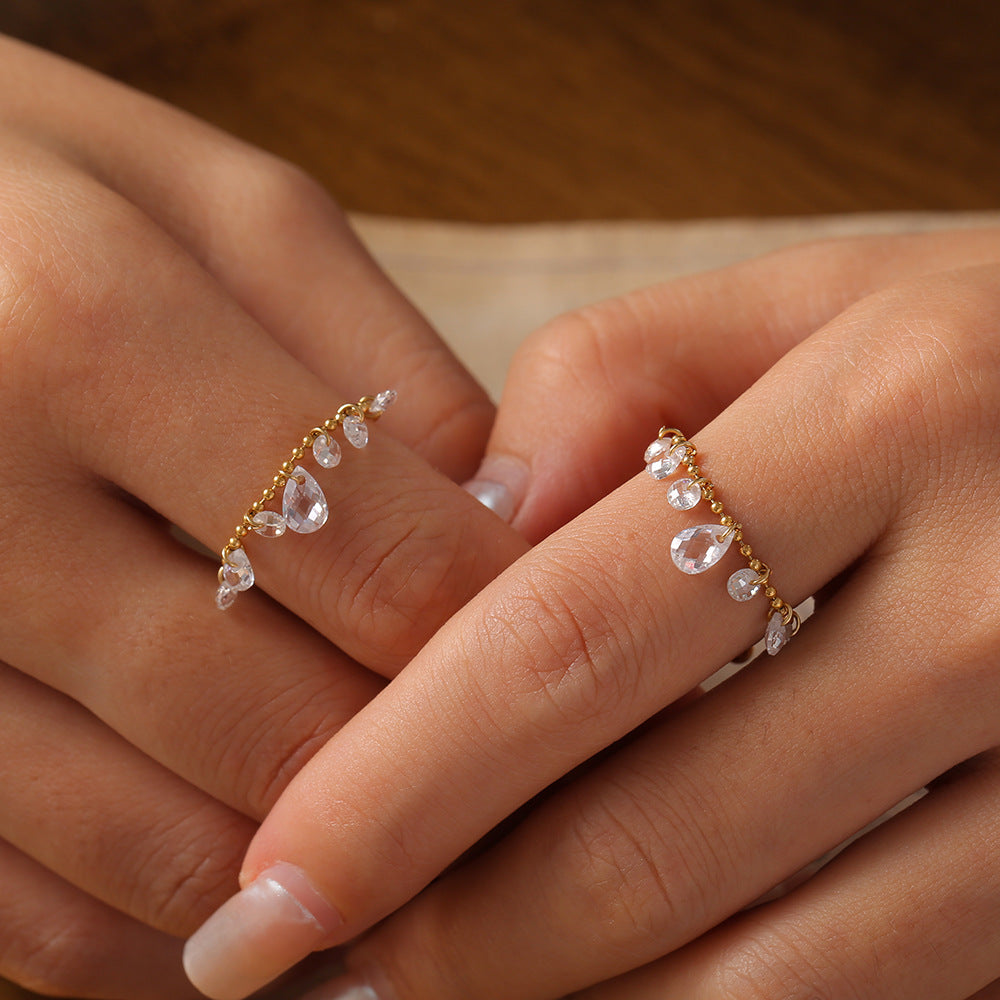 SEVEN CRYSTAL RINGS WITH TASSELS